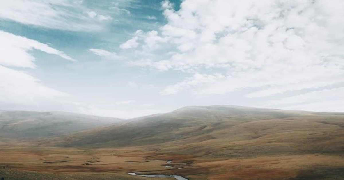 Explore the serene grasslands and river meandering through the Ağrı mountains in Türkiye.